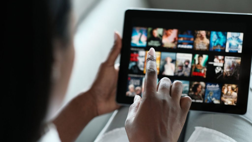 Black Woman Browsing Movie On Streaming Media Service